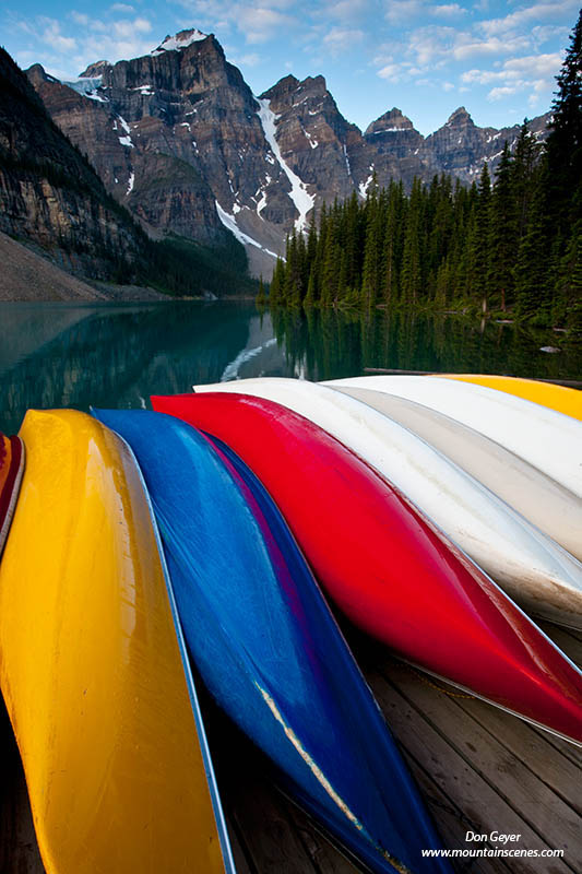 Image of Canoes at Moraine Lake below Wenkchemna Peaks