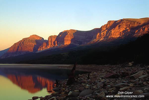 Image of Early light on Altyn Mountain reflected in Swiftcurrent Lake.