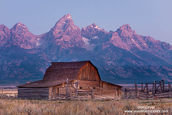 Image of Grand Teton above barn on Mormon Row before sunrise, Grand Teton National Park