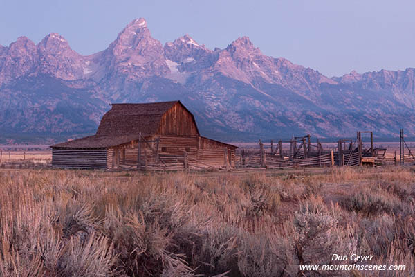 Image of Grand Teton above barn on Mormon Row before sunrise, Grand Teton National Park