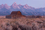 Image of Tetons above a barn on Mormon Row at dawn, Grand Teton National Park